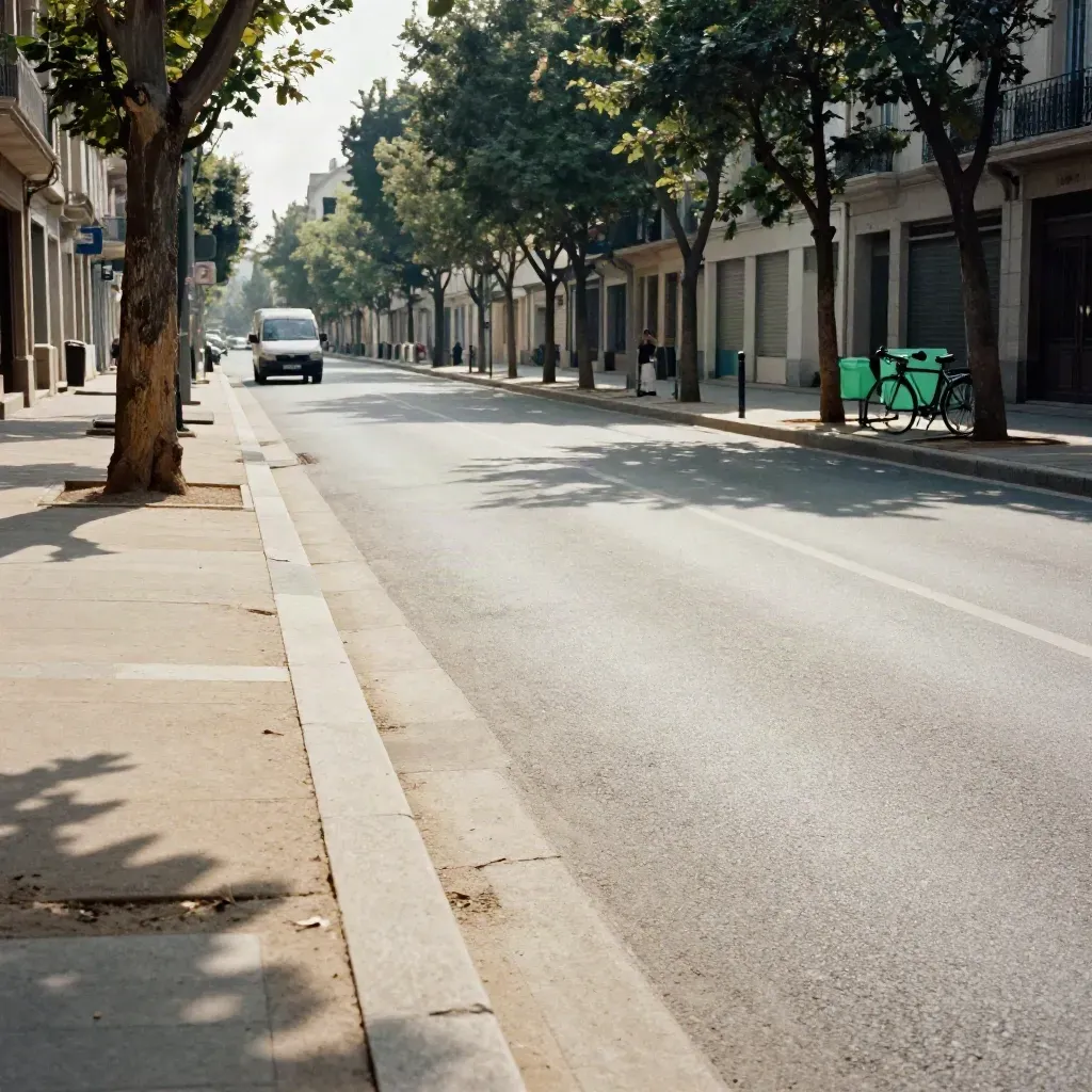 Rue apaisée avec arbres alignés, voie partagée et livraison discrète au loin.